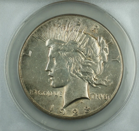 1928 Peace Dollar struck-through error – close-up showing impression of debris trapped between die and planchet during striking